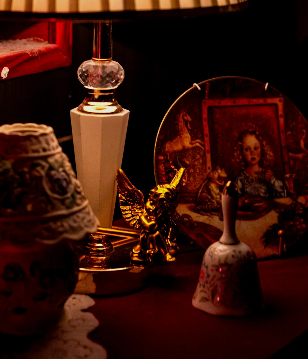 Red sculptural lamp and objects arranged as a dramatic studio still life